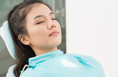 woman sleeping in dental chair for sedation dentistry