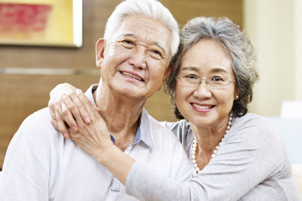 an older couple smiling together.