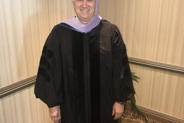 Dr. Kosinski in cap and gown for graduation
