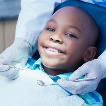 a young boy smiling in the dental chair.