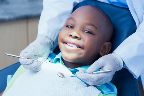 a young boy smiling in the dental chair.