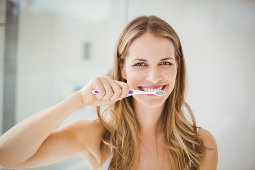 woman brushing her teeth