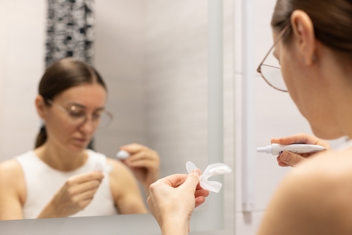 Woman,Preparing,Silicon,Tray,For,Teeth,Whitening